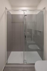 a glass shower in a bathroom with two toilets at Noah Charme in Rome
