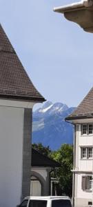 a view of a mountain from between two buildings at Vreni`s Ferienwohnung in Gais