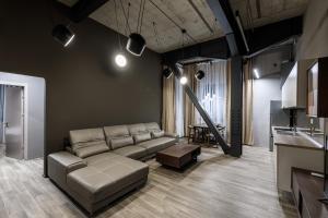 a living room with a couch and a table at ArtHomes Apartments in Timişoara