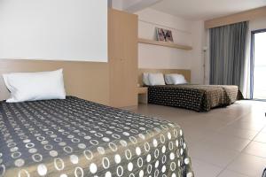 a hotel room with two beds and a window at Kyridis Hotel in Komotini