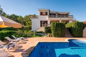 a villa with a swimming pool and a house at Finca Ceguer MHM in Font de Sa Cala