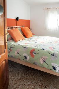 a bedroom with a bed with a colorful comforter at Casa Mas Montañas in Godelleta +24 photos