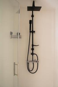 a shower with a cross hanging on a wall at Casa Mas Montañas in Godelleta