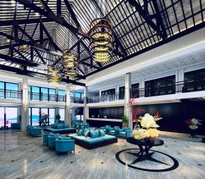 a large lobby with blue couches and a table at Dankbaar Resort Quy Nhon in Quy Nhon