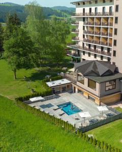 an aerial view of a building and a swimming pool at Linta Hotel Wellness & Spa in Asiago
