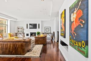 a living room with couches and a tv at Swainson on Waymouth - Penthouse in Adelaide