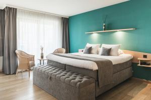 Een bed of bedden in een kamer bij Boutique Hotel 'Hof ter Duinen'