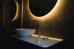 a bathroom sink with a white bowl on a counter at Villa Rosa - Garden in Detmold