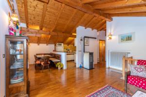 a kitchen and living room with wooden ceilings at Casa Fagher in Canale dʼAgordo