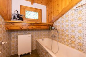 a bathroom with a tub and a window at Casa Fagher in Canale dʼAgordo +22 photos