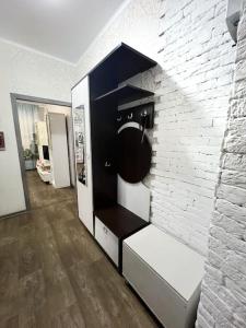 a room with a black and white brick wall at Квартира in Ustʼ-Kamenogorsk