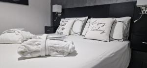 un letto con cuscini bianchi e un cuscino a forma di tacchino felice di Appartamento Camilla a Siniscola