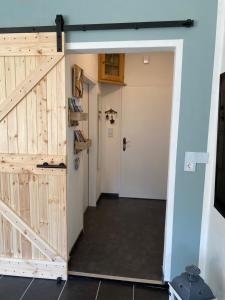 a barn door leading into a hallway with a room with a door at Gebirgszauber in Walchsee