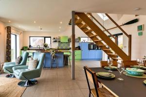 a kitchen and living room with a table and chairs at Finest Retreats - Blue Seas in Mousehole +49 photos