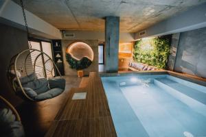 a house with a swimming pool with two chairs at "The House" Апартаменти и Термална зона in Velingrad
