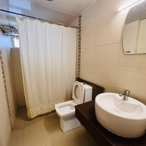 a bathroom with a sink and a toilet at Pepper Route, Fort Kochi in Fort Kochi