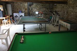 a ping pong table in a room with a pool table at L'Aide Frechu in Mortain