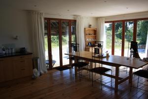 a kitchen with a table and chairs in a room at L'Aide Frechu in Mortain