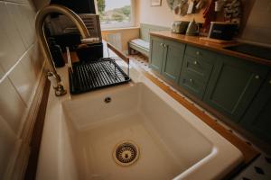 a kitchen sink with a laptop sitting on top of it at Spacious, Luxury home nr Cartmel & Lake Windermere in Grange Over Sands