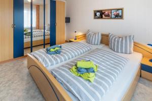 a bedroom with two beds with towels on them at Ferienhaus Seeschwalbe in Norddeich