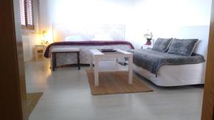 a living room with a couch and a table at Lovely Cat's B&B in Urrúnaga