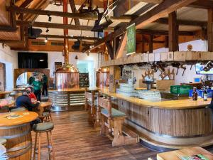 a restaurant with a bar with people sitting at tables at Hotel Brauhaus Wiesenmühle in Fulda