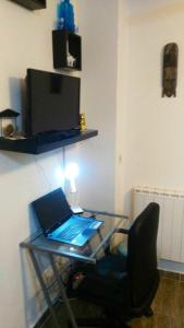 a glass desk with a laptop computer on a chair at Modern apartment in Torrevieja with terrace – 58 m² in Torrevieja