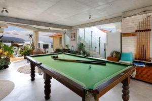 a pool table in the middle of a living room at Sandon Point Coastal Abode in Bulli