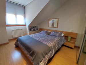 A bed or beds in a room at Los Molinos - Atico en Montaña de Asturias