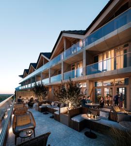 a rendering of a hotel patio with tables and chairs at Boutique Hotel Blendin Bloemendaal aan Zee in Overveen
