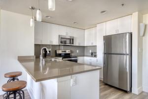 a kitchen with white cabinets and a stainless steel refrigerator at Mountain View 2BR w Gym Lounge nr Highways SFO-1080 in Los Altos