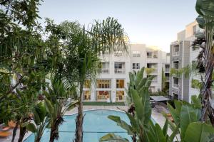 a swimming pool in the middle of a building with trees at San Mateo 2br w gym pool clubhouse wd nr 101 SFO-1249 in San Mateo