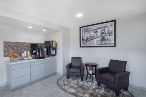 a waiting room with two chairs and a counter at Super 8 by Wyndham Charlottesville in Charlottesville