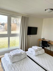 Postel nebo postele na pokoji v ubytování Vandrarhem Nattmössan