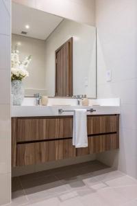 a bathroom with a sink and a large mirror at Dream holiday home+private pool in Ras al Khaimah