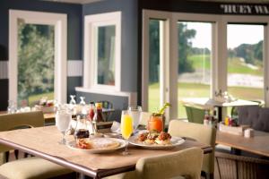 a table with plates of food and glasses of orange juice at Wild Dunes Resort - Sweetgrass Inn and Boardwalk Inn in Isle of Palms