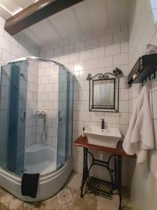 a bathroom with a tub and a sink and a shower at Marelle Porta in Veresegyház