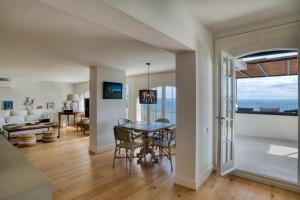 a dining room and living room with a table at Hauzify I Casa Bonet in Llafranc