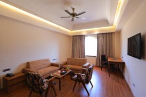 a living room with a couch and a table at Regenta Central City Vilas Palace Ambala in Ambāla