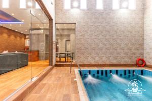 a swimming pool in the middle of a building at Shalalat Al Ghaba Chalets in Taif