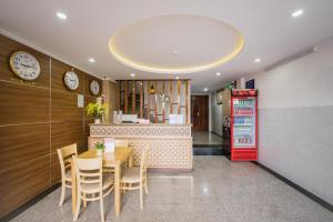 a restaurant with a table and chairs and a counter at Phú Xuân Hotel in Quy Nhon