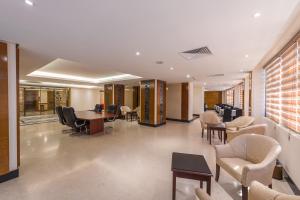 a waiting room with chairs and tables in a building at Joury Al Mashaer Hotel in Mecca