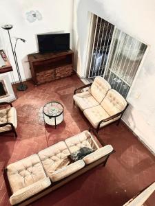 a living room with two couches and a flat screen tv at Casa Coriska in Algoz