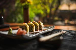 a group of sushi on a plate on a table at The Dwarika's Hotel in Kathmandu