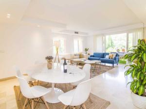 a living room with a white table and chairs at Golden Mile Oasis in Marbella