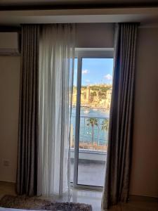 a large window with a view of the ocean at SouthShore Accommodation in Marsaskala
