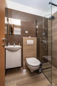 a bathroom with a toilet and a sink and a shower at Apartment Thalia in Zadar +25 photos