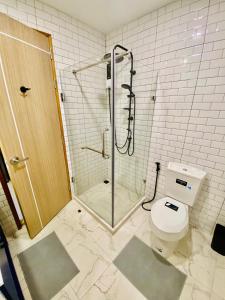 a bathroom with a shower and a toilet at Bann Chidtha family suite full kitchen near Suvarnabhumi Airport in Bangkok +111 photos