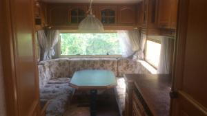 a living room with a couch and a table in an rv at Summer bungalo trailer in Jūrmala
