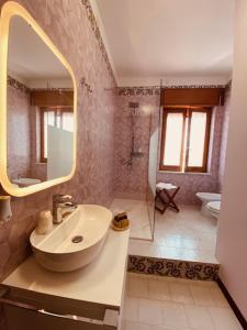 a bathroom with a sink and a mirror at San Pietro in Noto